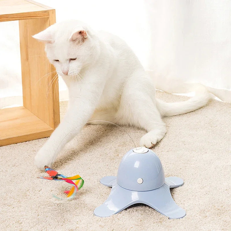White cat playing with a colorful toy on a beige carpet